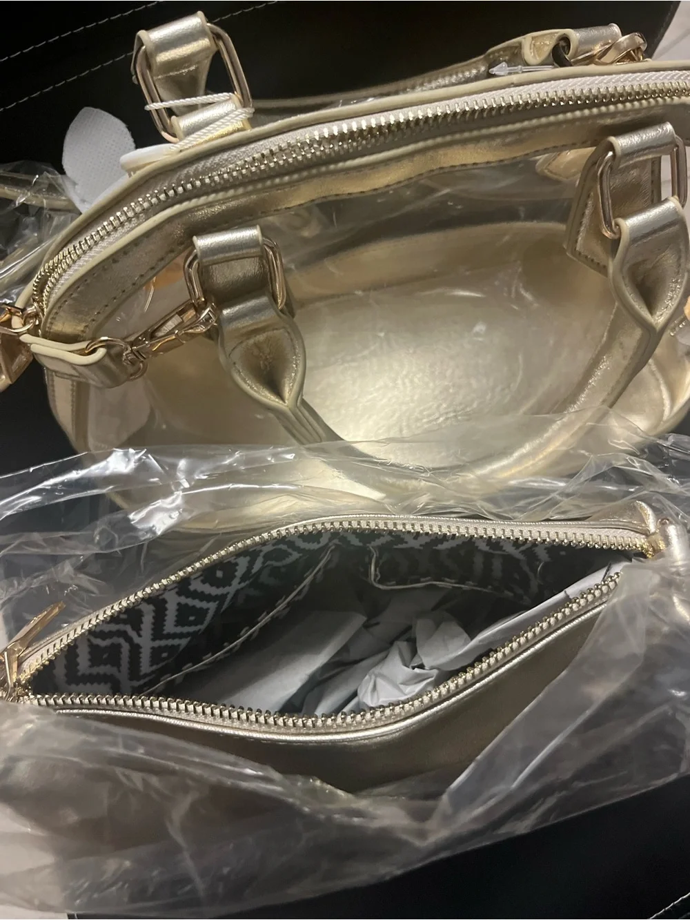Gold clear two and one purse with handles and gold straps.